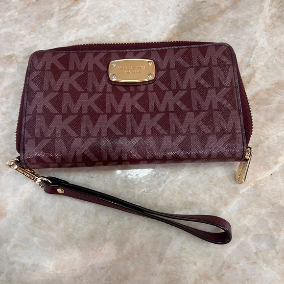 Michael Kors Handbags - M Kors NWOT Merlot purple monogram Wristlet Wallet